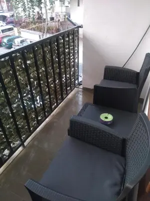 a balcony with two chairs and a table at Room Rada in Ulcinj