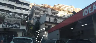 a city street with cars parked in front of buildings at Room Rada in Ulcinj