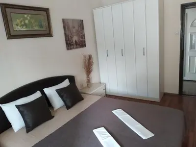 a bedroom with a bed with black and white pillows at Room Rada in Ulcinj