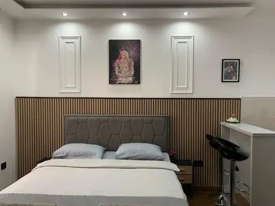 a bedroom with a large bed and two pictures on the wall at AD luxury in Podgorica