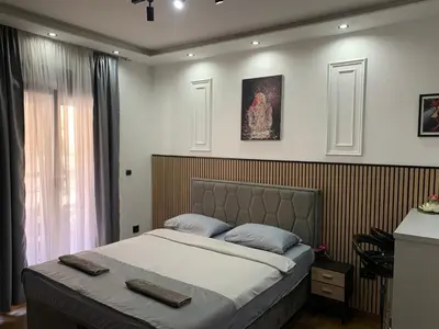 a bedroom with a large bed in a room at AD luxury in Podgorica