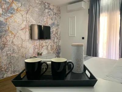 a tray with two coffee mugs on top of a bed at AD luxury in Podgorica
