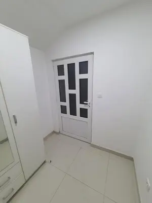 a white room with a door and a mirror at Apartman Tolosi 2 in Podgorica