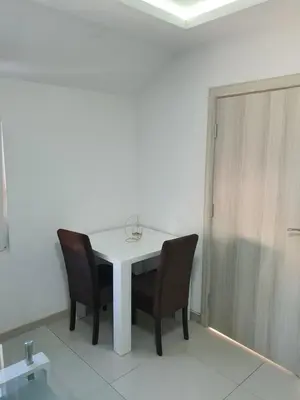 a white table and chairs in a room at Apartman Tolosi 2 in Podgorica