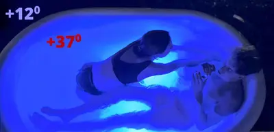 a couple of people in a blue bath tub at House in the pines in Sutomore