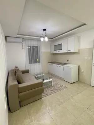 a living room with a couch and a kitchen at Days Inn Long Beach in Ulcinj