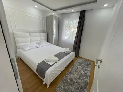 a small bedroom with a white bed and a window at Days Inn Long Beach in Ulcinj