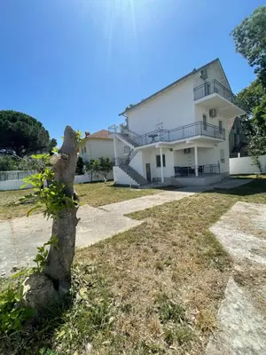 a house with a tree in front of it at Days Inn Long Beach in Ulcinj