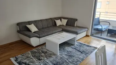 a living room with a couch and a table at Apartman A1 in Ulcinj