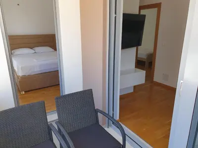 a room with two chairs and a bed and a mirror at Apartman A1 in Ulcinj
