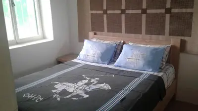 a bedroom with a bed with a horse blanket and pillows at Holiday home Panorama in Sutomore