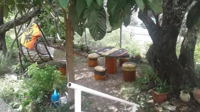 a hammock and a bench under a tree at Holiday home Panorama in Sutomore