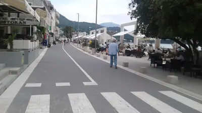 a man walking down a street in a city at Holiday home Panorama in Sutomore