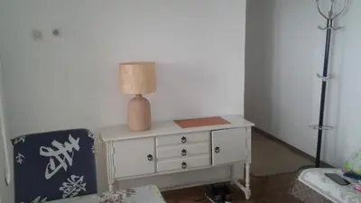 a white dresser with a lamp on top of it at Holiday home Panorama in Sutomore