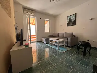 a living room with a couch and a table at GRAMISI apartments in Kruče