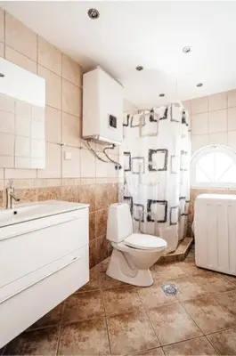 a bathroom with a toilet and a shower and a sink at D & S Family Apartments Budva in Budva