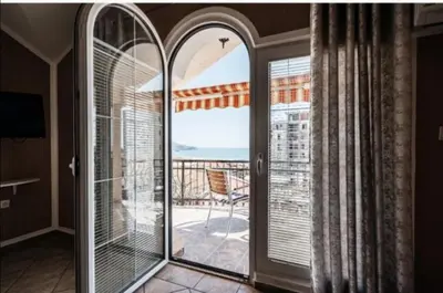 a room with a large window with a view of a balcony at D & S Family Apartments Budva in Budva