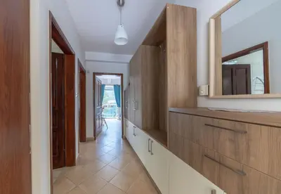 a kitchen with wooden cabinets and a mirror at Dobrota Blue in Kotor