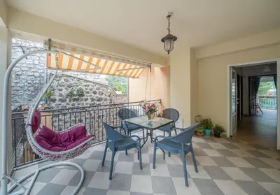 a patio with a table and chairs on a balcony at Dobrota Blue in Kotor