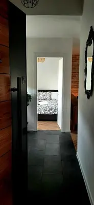 a room with a bedroom with a bed in the background at Ric Apartment Budva in Budva