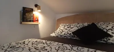 a bedroom with a bed with a black pillow on it at Ric Apartment Budva in Budva