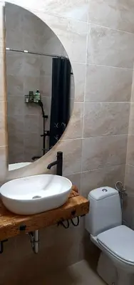 a bathroom with a sink and a toilet and a mirror at Ric Apartment Budva in Budva