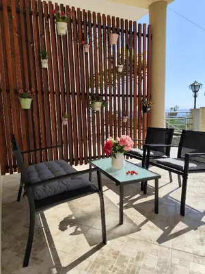 a patio with two chairs and a table and a fence at Holiday home N&S in Bar