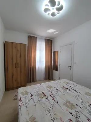 a bedroom with a large bed and a light on the ceiling at Holiday home N&S in Bar