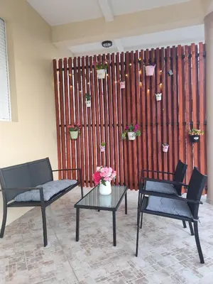 a living room with two chairs and a table at Holiday home N&S in Bar