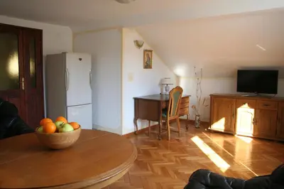a living room with a table with a bowl of fruit at Spacious 2Bedroom Flat Budva Becici in Boreti