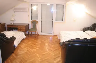 a bedroom with two beds and a desk and a chair at Spacious 2Bedroom Flat Budva Becici in Boreti