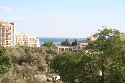 a city with buildings and the ocean in the background at Spacious 2Bedroom Flat Budva Becici in Boreti