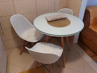 a white table with two chairs and a book on it at Ljubovic apartman in Podgorica