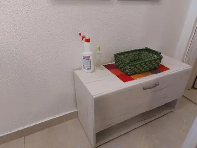 a white cabinet with a bottle on top of it at Ljubovic apartman in Podgorica