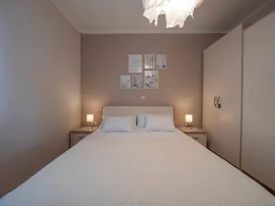 a bedroom with a large white bed with two lamps at Workation Panorama Escape in Budva