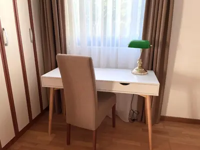 a desk with a chair and a lamp on it at Sunset Poolside Retreat BlueH in Budva