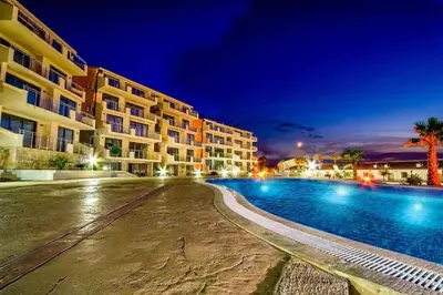 a hotel with a swimming pool at night at Sunset Poolside Retreat BlueH in Budva