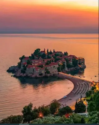 a small island in the water at sunset at Sunset Poolside Retreat BlueH in Budva