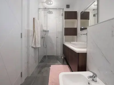 a white bathroom with a shower and a sink at Luxury apartment with Sea view Przno, Sveti Stefan, Regina Residence in Pržno