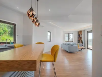 a living room with a dining table and yellow chairs at Luxury apartment with Sea view Przno, Sveti Stefan, Regina Residence in Pržno