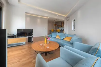a living room with a blue couch and a table at Luxury apartment with Sea view Przno, Sveti Stefan, Regina Residence in Pržno