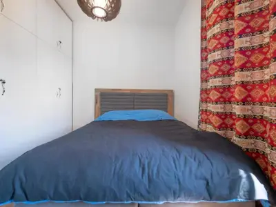 a bedroom with a blue comforter on a bed at Luxury apartment with Sea view Przno, Sveti Stefan, Regina Residence in Pržno