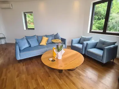 a living room with a blue couch and a table at Luxury apartment with Sea view Przno, Sveti Stefan, Regina Residence in Pržno