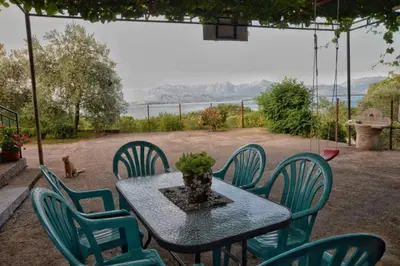 a table and chairs with a vase on it at house for rent 