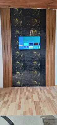 a television screen with a box on a wall at house for rent 