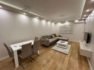 a living room with a couch and a table at Central City Lux Apartments in Podgorica