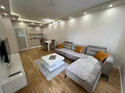 a living room with a couch and a table at Central City Lux Apartments in Podgorica