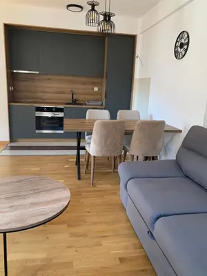 a living room with a blue couch and a table at Apartman Jedro Lux in Rafailovici