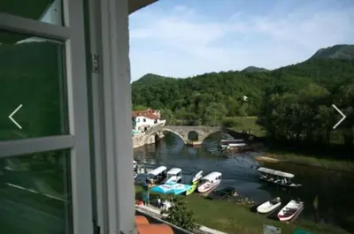 a view from a window of a river with boats at Hotel S Family Jovicevic in Rijeka Crnojevića