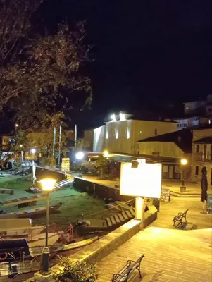 a building with a sign in front of it at night at Hotel S Family Jovicevic in Rijeka Crnojevića